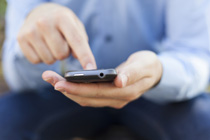 Man dialing a number on a smart phone